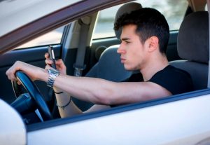 17 years old teen driving and using mobile